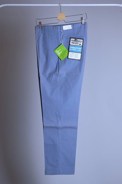 Side profile of a dusty blue pair of vintage Permanent Press tapered slacks showing the slim 70s silhouette and wrinkle-resistant fabric.