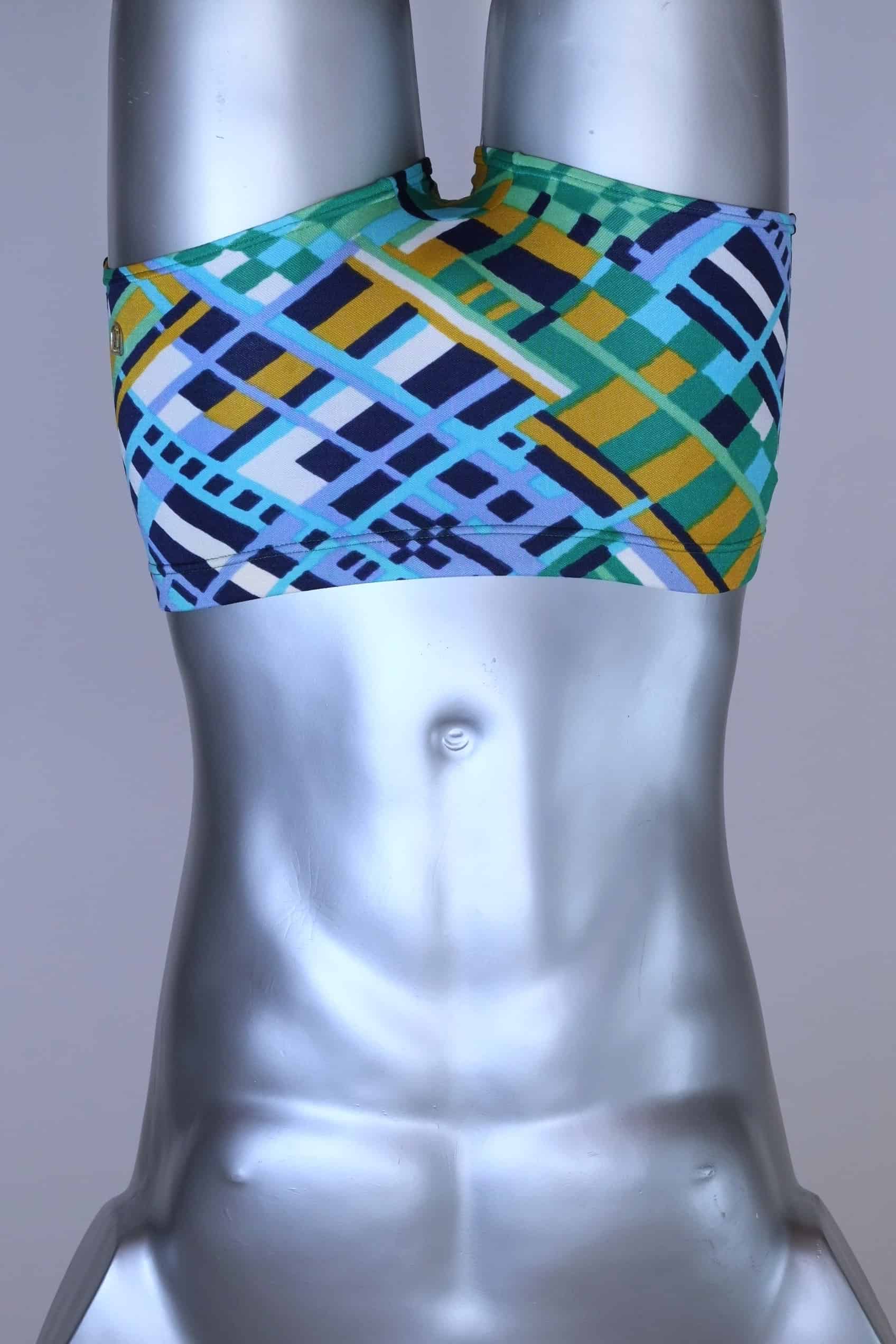 Front view of vintage 70s Ribana swim trunks in a geometric print with cool tones of blue, green, yellow, and navy, modeled on a silver mannequin.