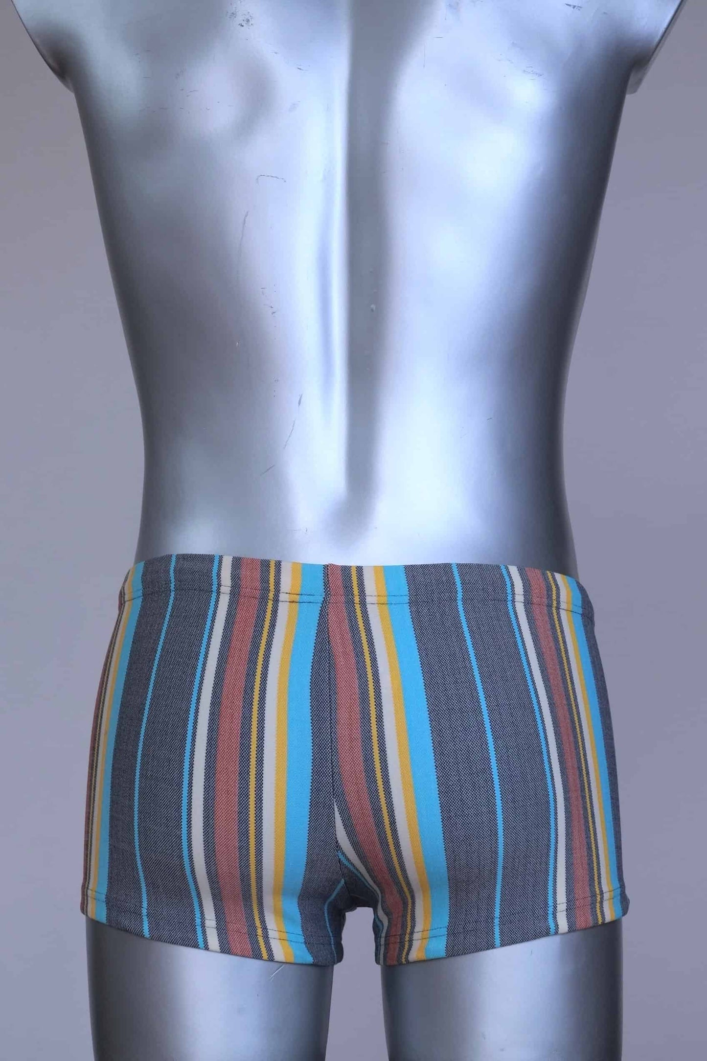 Back view of RIBANA vintage 70s swim trunks in shades of blue striped pattern, shown on a silver mannequin.