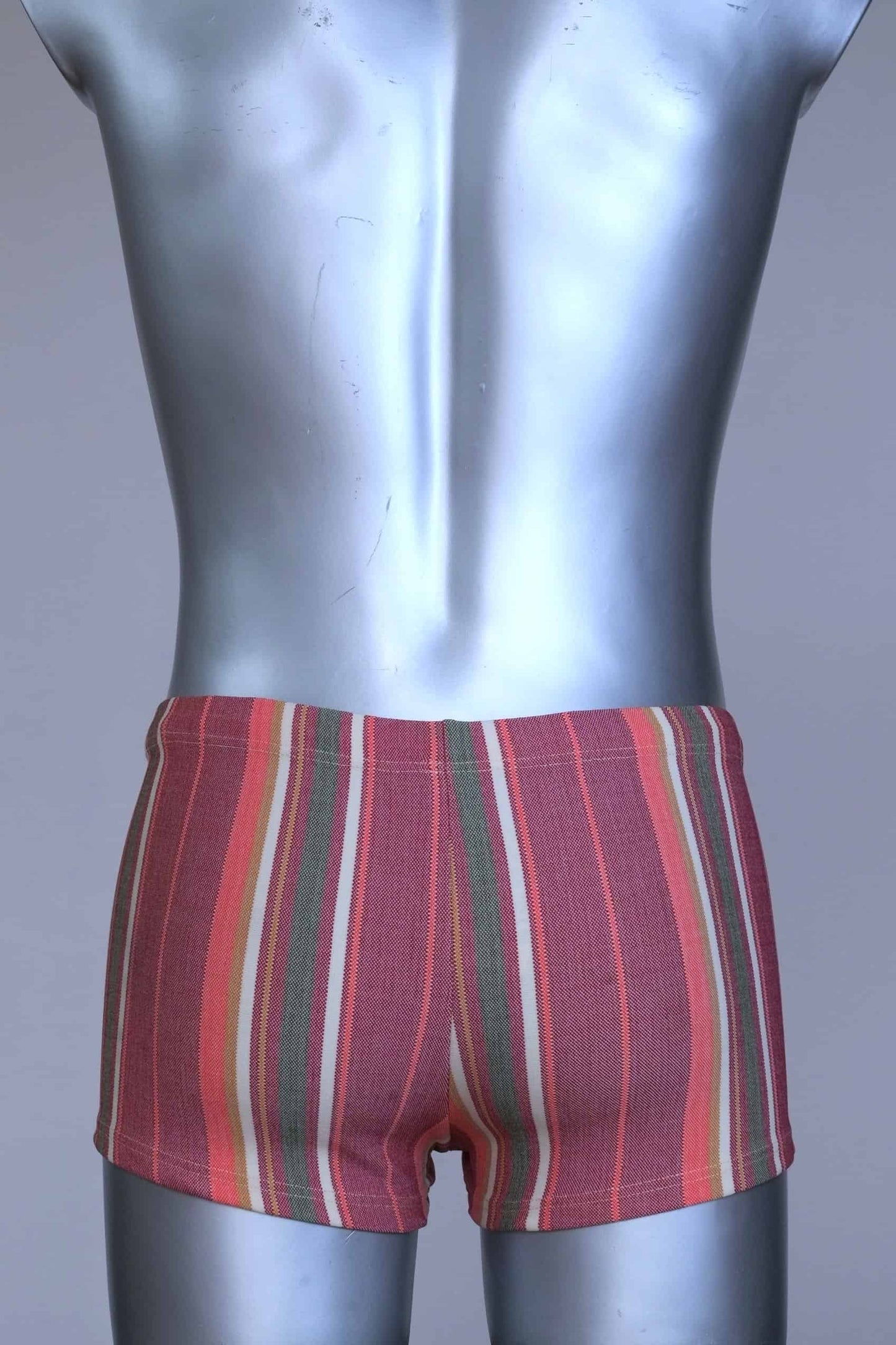 Back view of RIBANA vintage 70s swim trunks in shades of red and striped pattern, shown on a silver mannequin.