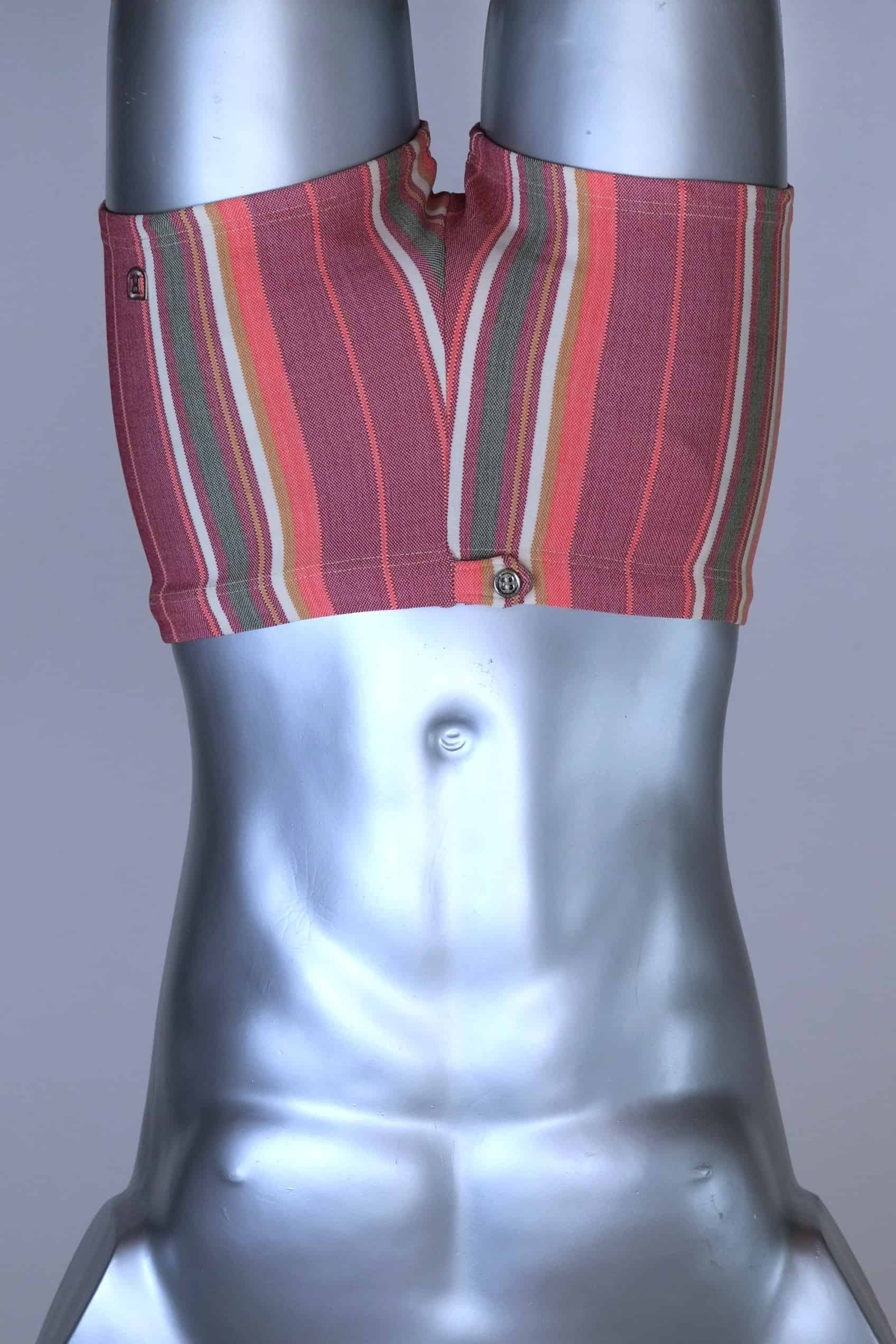 RIBANA vintage 70s swim trunks in shades of red and striped pattern, shown on a silver mannequin.