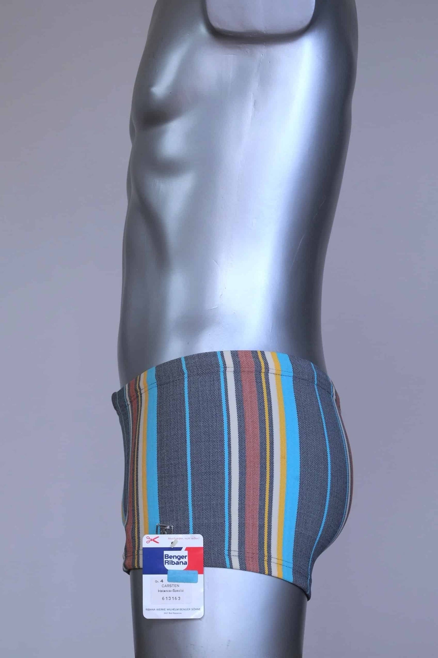 Side view of RIBANA vintage 70s swim trunks in shades of blue striped pattern, shown on a silver mannequin.