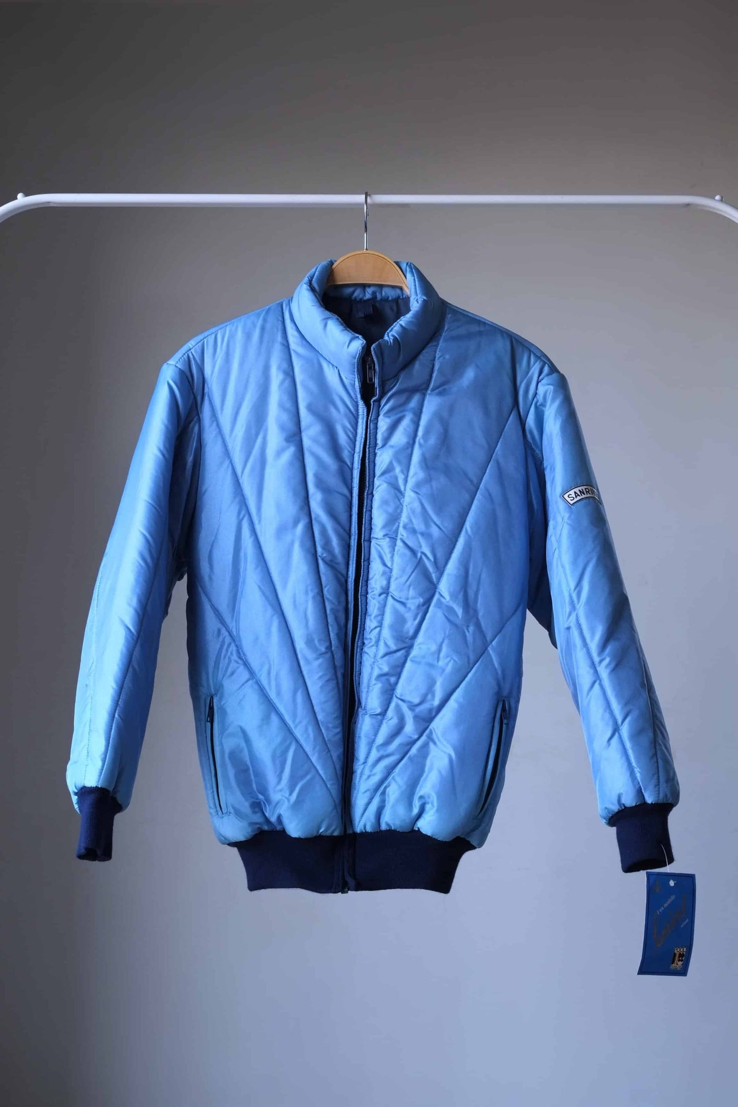 SANRIVAL Vintage 70's Ski Jacket on hanger. color: mettalic blue. 