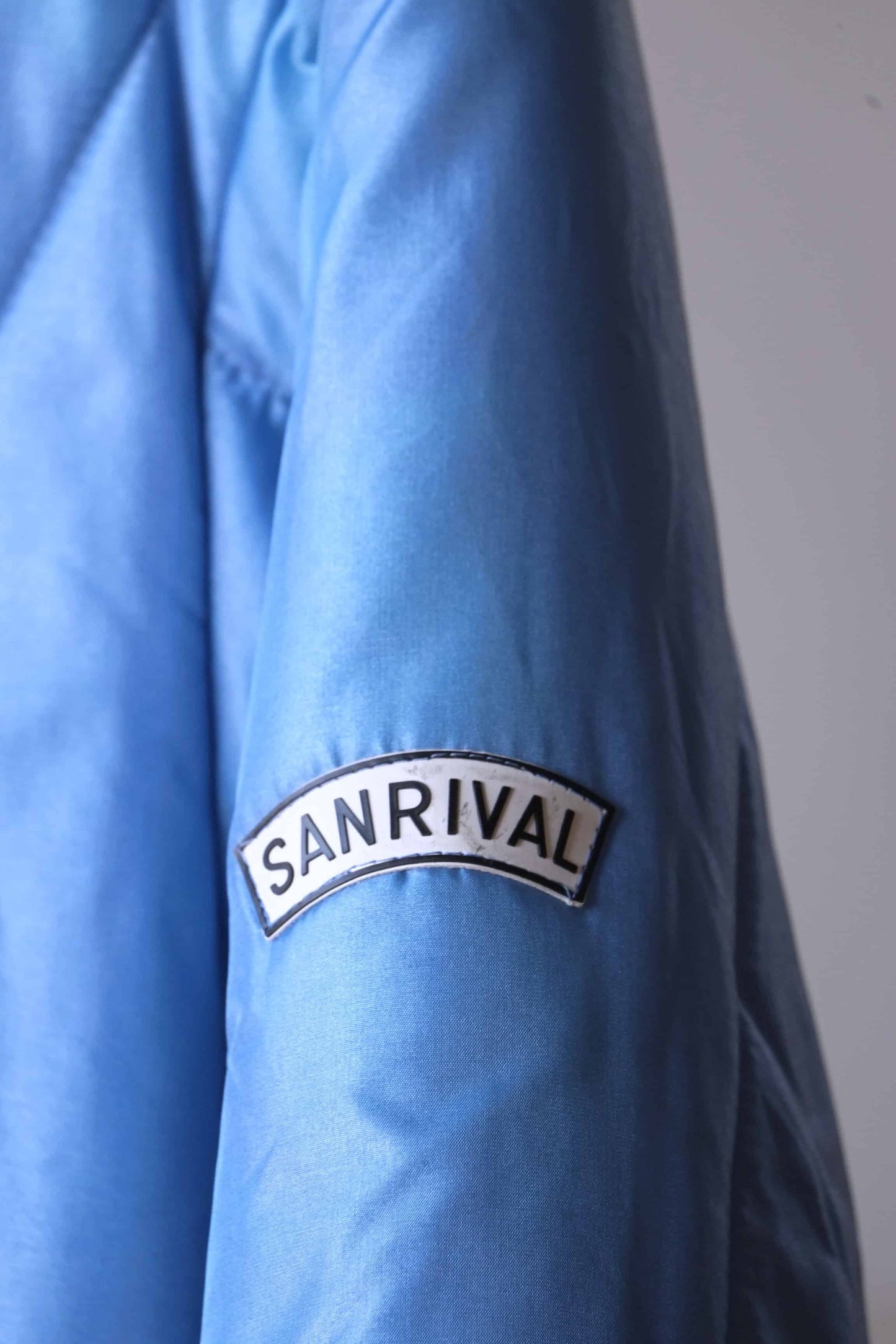 Detail of logo on the sleeve of Sanrival vintage 70s ski jacket.