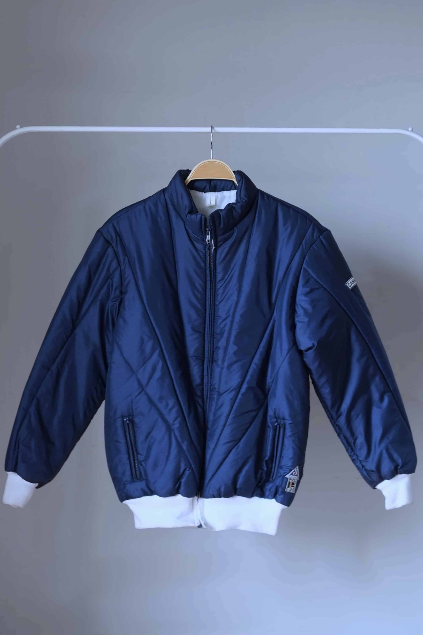 SANRIVAL Vintage 70's Ski Jacket on hanger, color: navy blue.