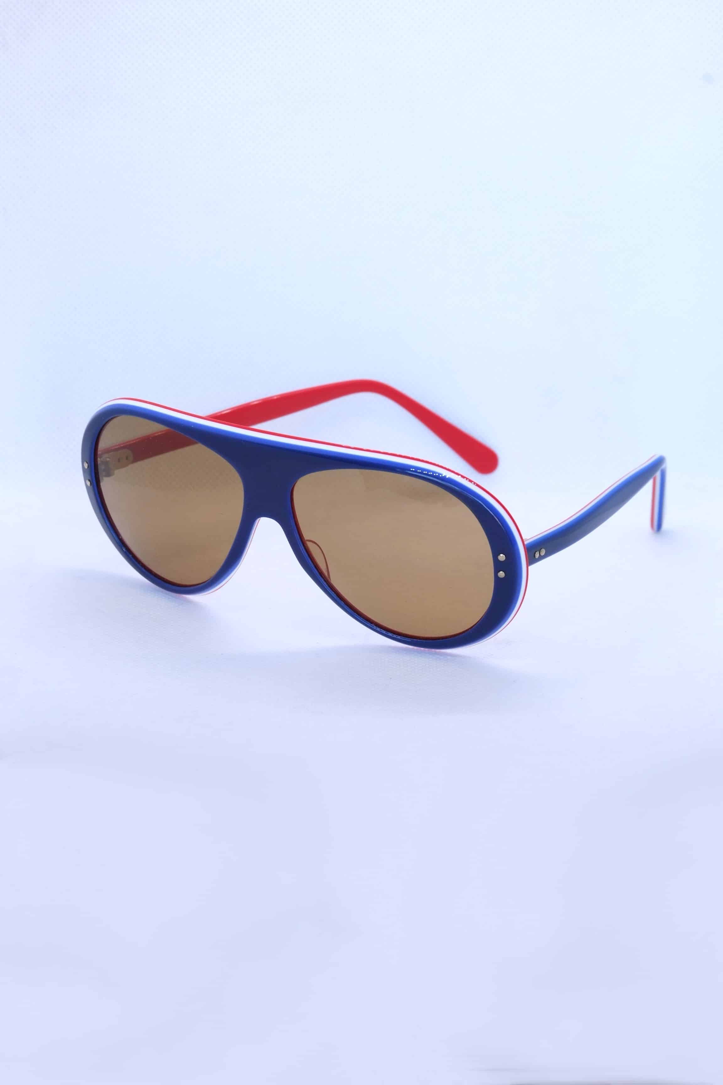 Navy and red 1970s vintage SKILOOK tricolor aviator sunglasses with brown lenses, featuring a thick dark navy acetate frame, white accent striping, and mismatched red and navy temples.