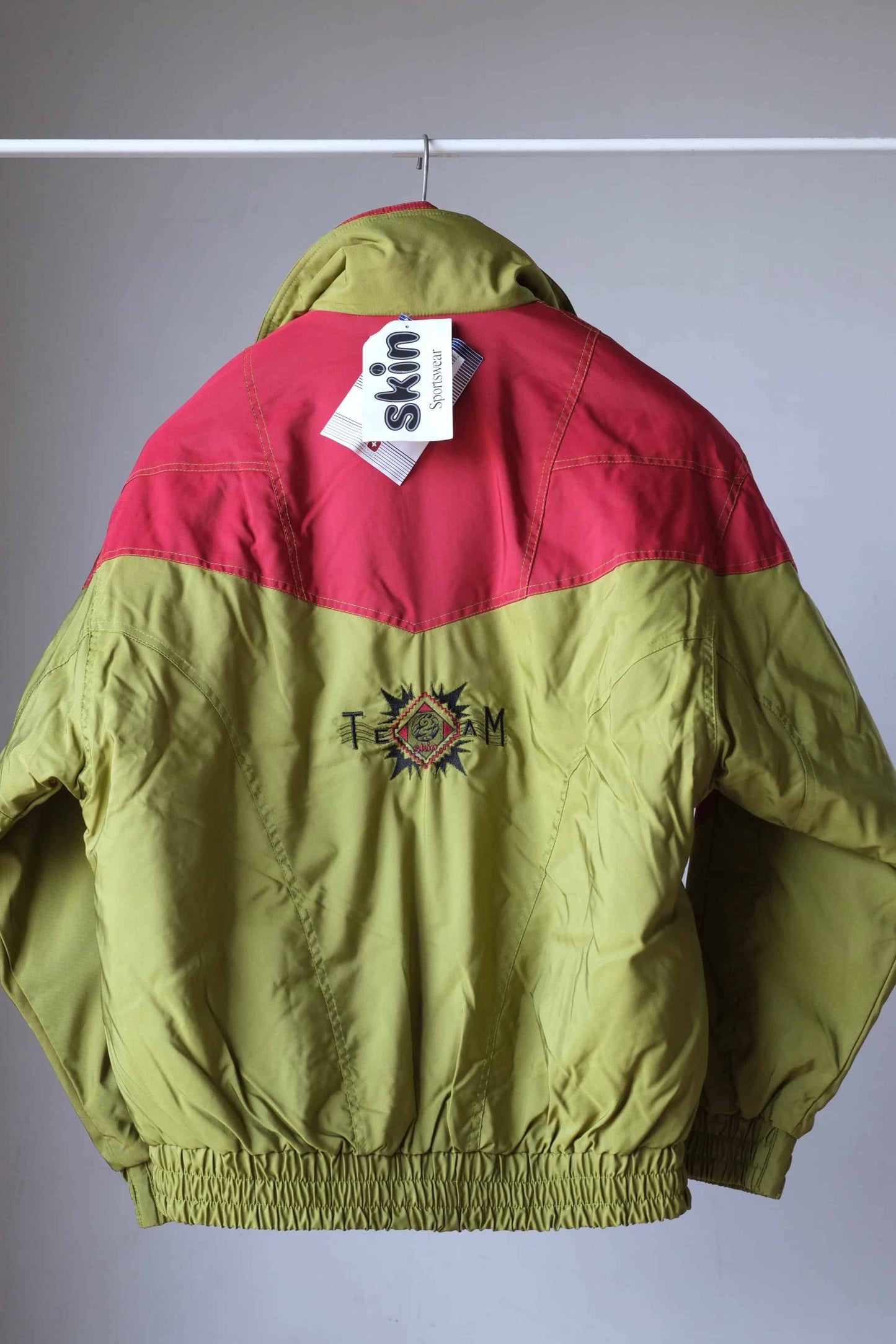 Back view of Vintage Men's 90's Ski Jacket in brick red and olive green