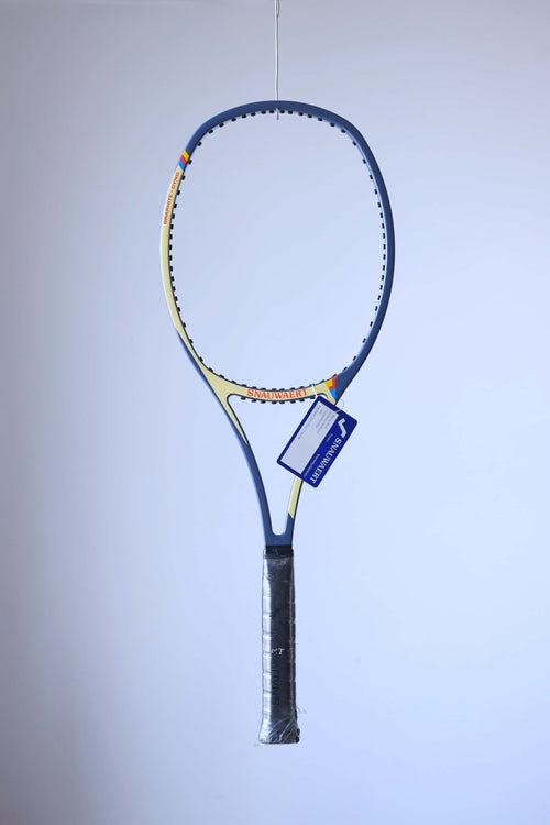 Studio full front shot of an unstrung variation of the racquet featuring a black grip and a blue Snauwaert warranty hang tag attached to the throat.
