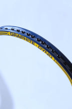 Macro side profile shot of the blue racquet frame highlighting a row of empty black string grommets along the outer channel.