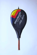 The vintage racquet inside its black protective cover, featuring the "SNAUWAERT" name, Miloslav Mečíř signature, and a red, yellow, and blue graphic.