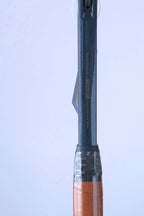 Detail of the racquet shaft above the grip, showing the gold text "MADE WITH PRECISION IN BELGIUM BY SNAUWAERT & DEPLA".
