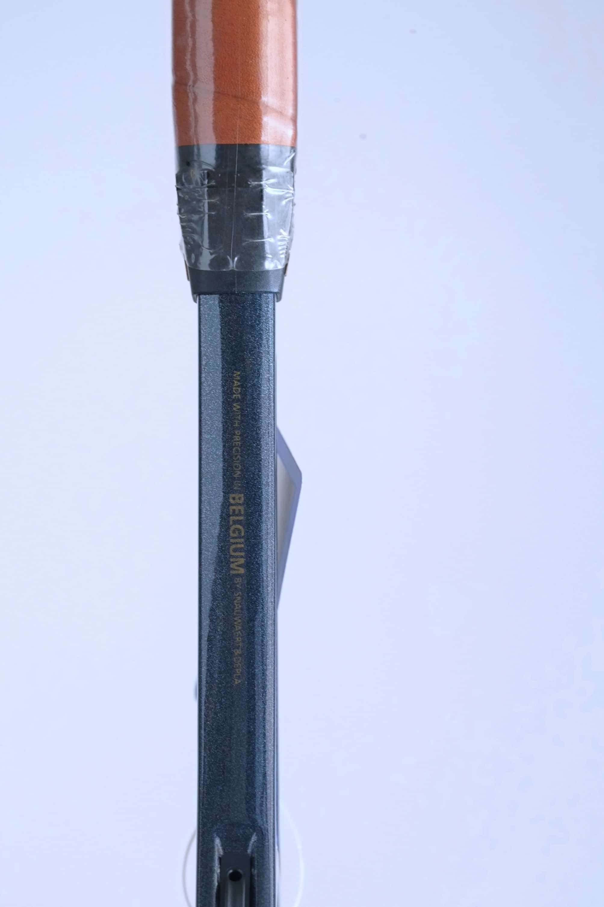 Detail of the racquet shaft above the grip, showing the gold text "MADE WITH PRECISION IN BELGIUM BY SNAUWAERT & DEPLA".