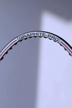 Macro view of the top of the unstrung hoop showing the "GRAPHITE-PRO" branding and the white and red pinstripe detailing.