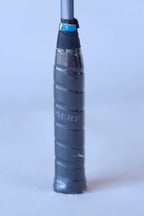 Close-up of the original textured black leather wrap grip on a vintage Snauwaert squash racket handle.
