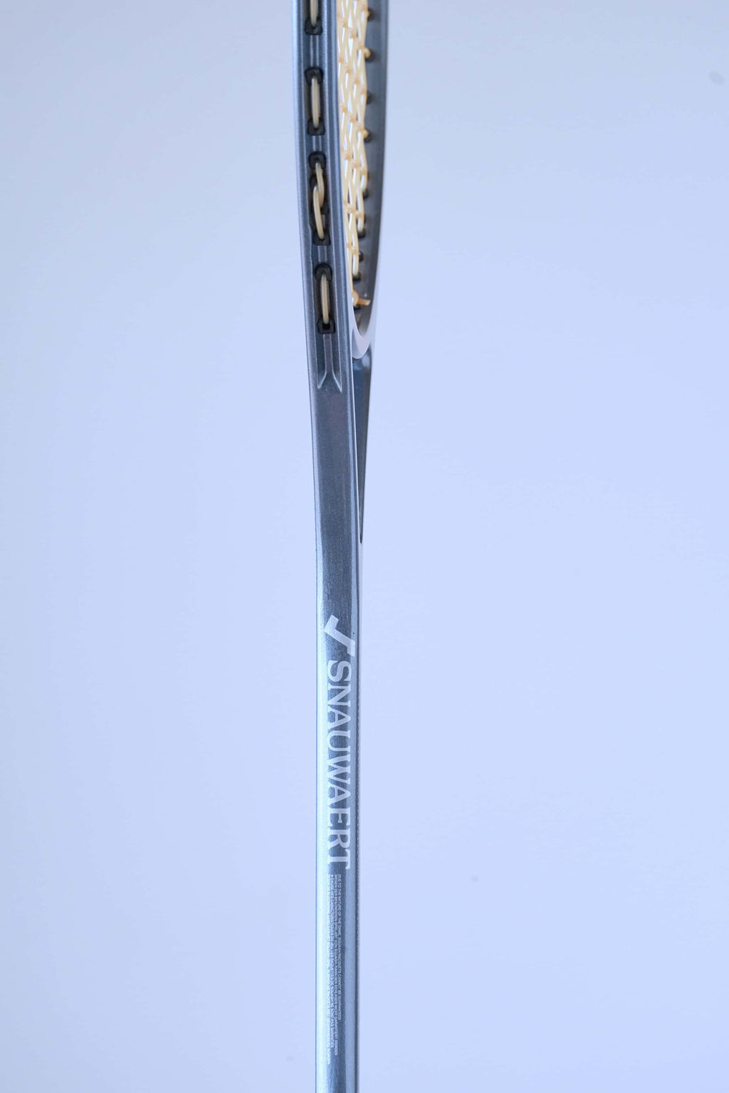 Side profile view of a vintage squash racket shaft showing the text Precision Crafted by Snauwaert & Depla Belgium.