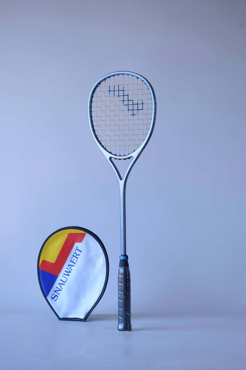 Full front view of a vintage strung Snauwaert Hi-Ten I squash racket standing against a plain background, next to its vinyl cover.
