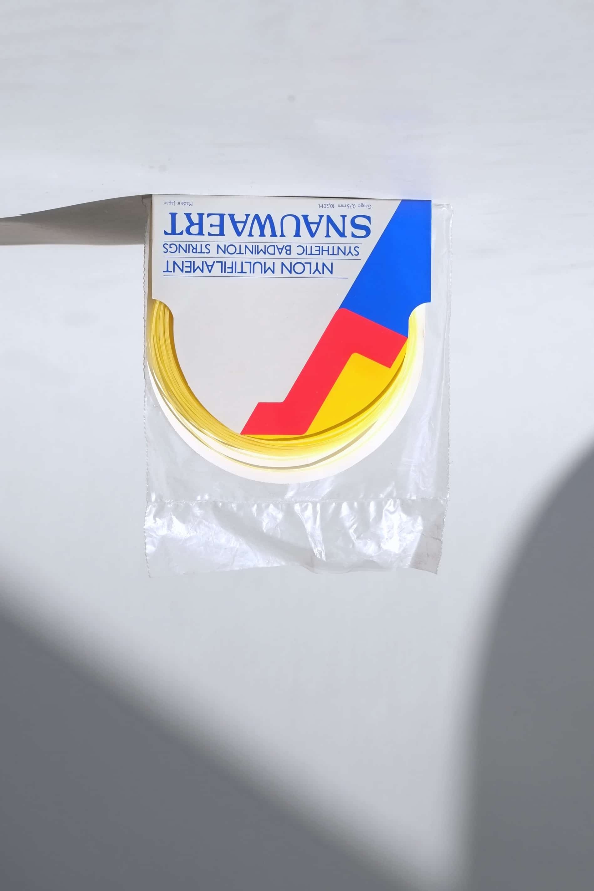 Deadstock vintage Snauwaert nylon multifilament badminton strings in original white and blue retail packaging.
