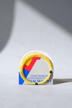 Close-up of a vintage pack of Snauwaert badminton strings, showing the retro logo design and product specifications.
