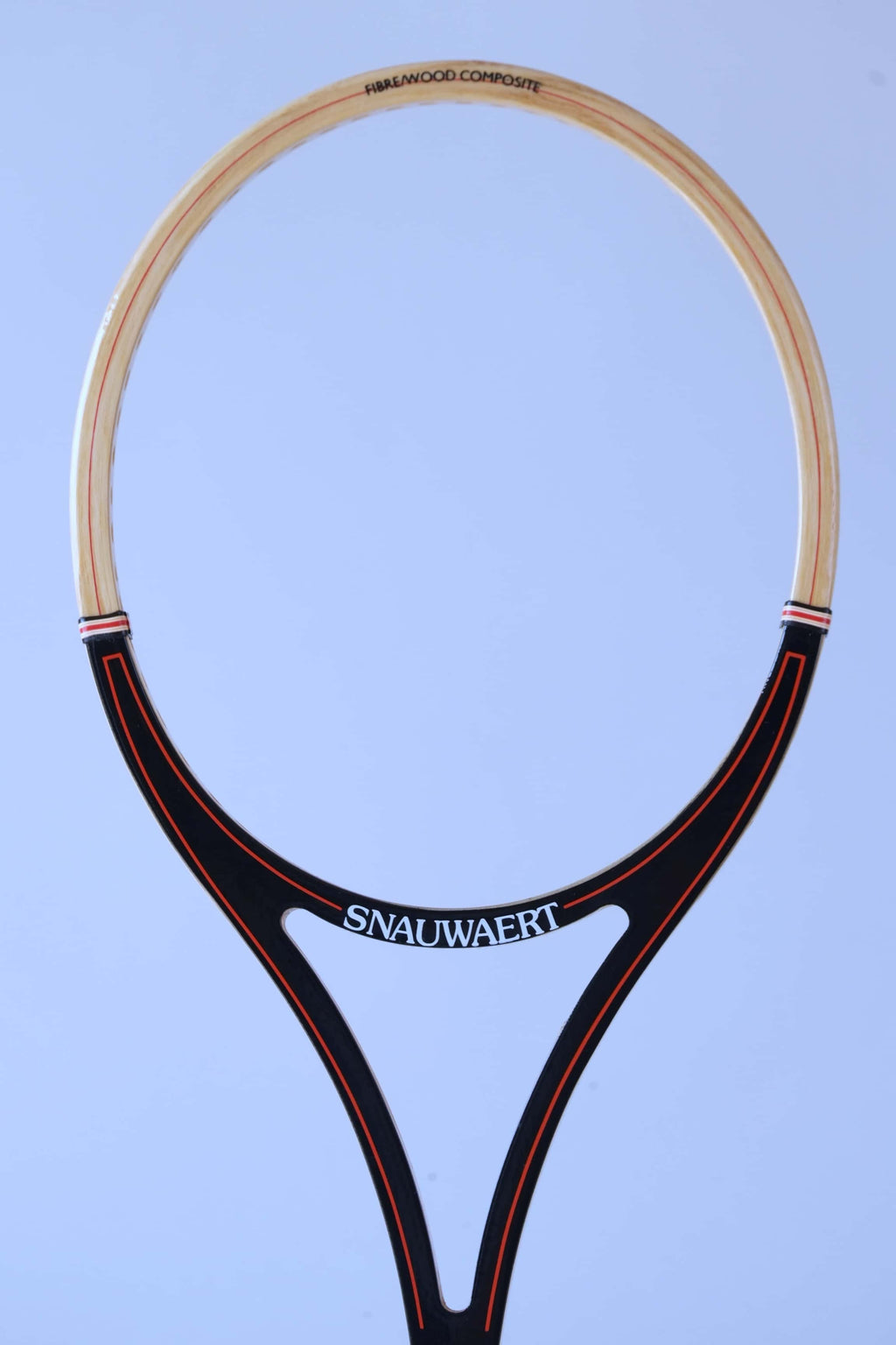 Close-up of the open split-throat design of a vintage Snauwaert squash racket with black and red graphics.