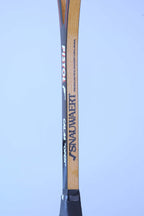 Close-up of a vintage squash racket shaft detailing the Snauwaert logo, Pistol model name, and Cal 44 Open text.