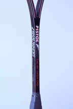 Close-up of a glossy black squash racket shaft showing the Snauwaert and Pistol logos alongside Cal 44 Open One text.