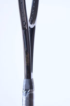 Profile shot of the racquet shaft detailing the material composition: "100% SPECIAL TREATED AND SELECTED GRAPHITE AND CERAMIC RAIDS".
