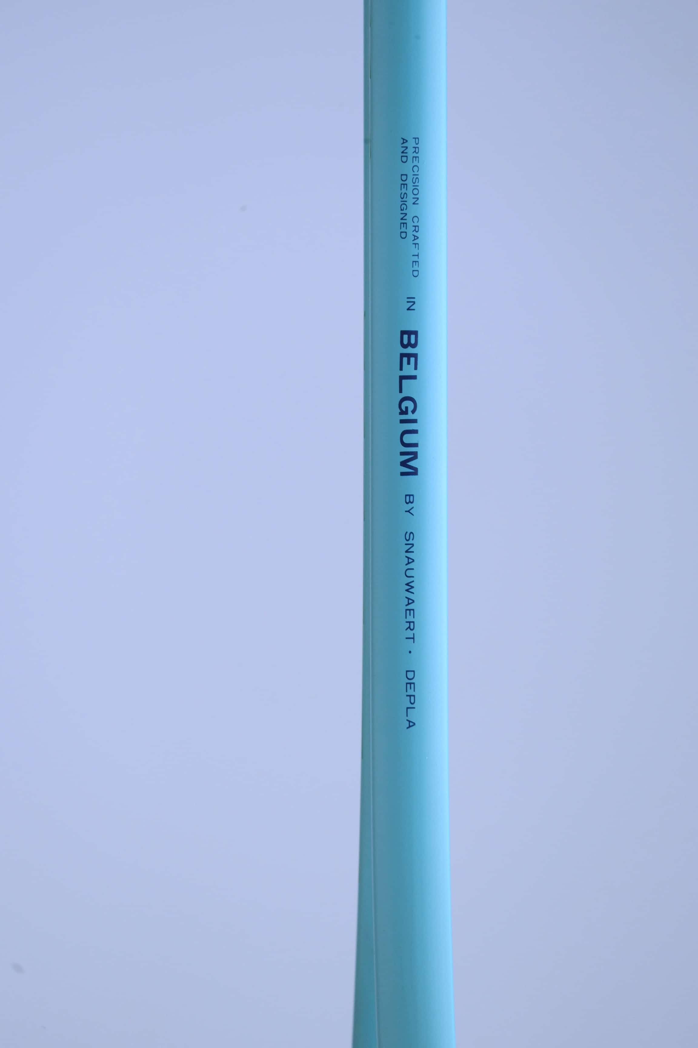 Close-up of the Snauwaert Shark 2 squash racquet shaft showing "Precision Crafted in Belgium by Snauwaert · Depla" text printed on the teal frame.