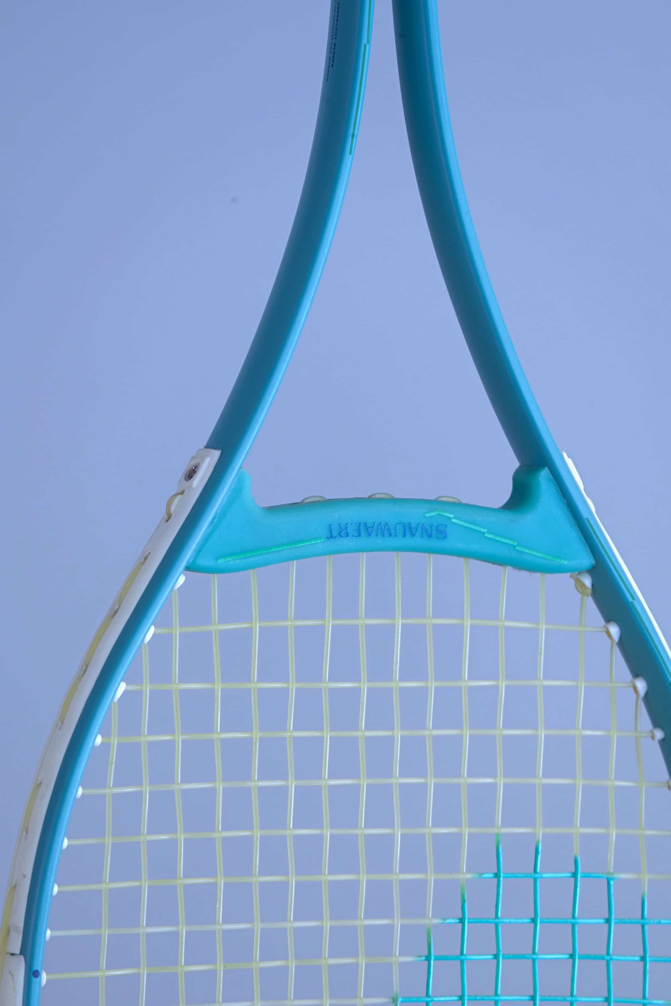 Close-up of the Snauwaert Shark 2 squash racquet throat bridge showing the teal open-throat Y design with Snauwaert branding and white bumper strip detail.