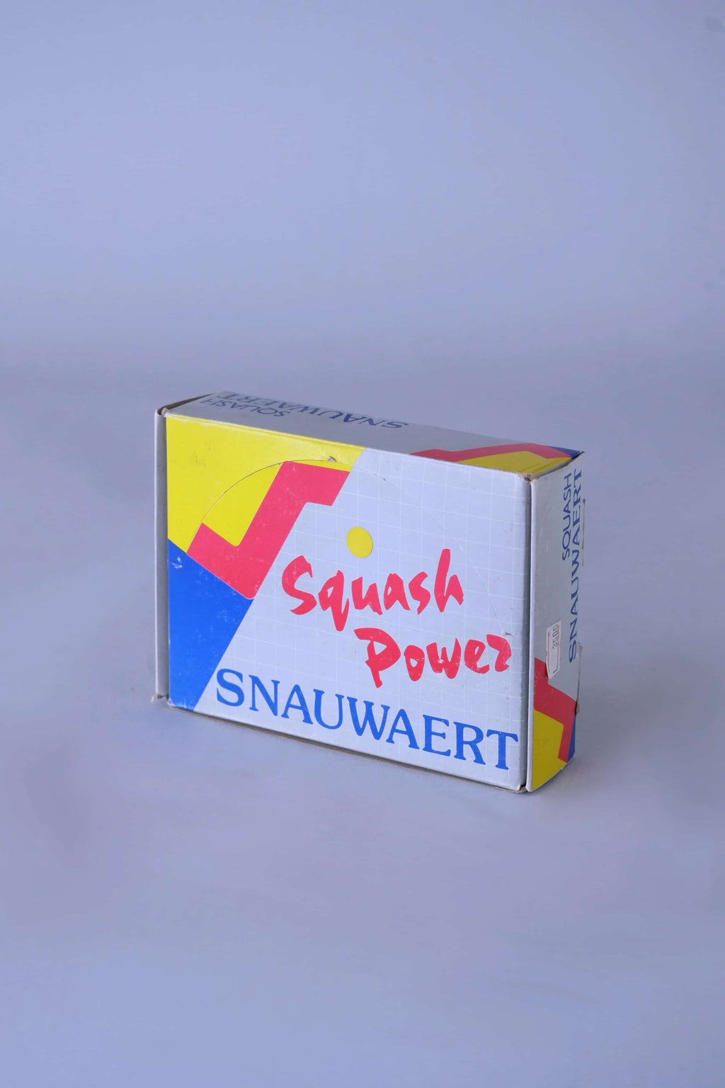 Close-up of the top of a vintage Snauwaert box showing the text in 'squash power'.
