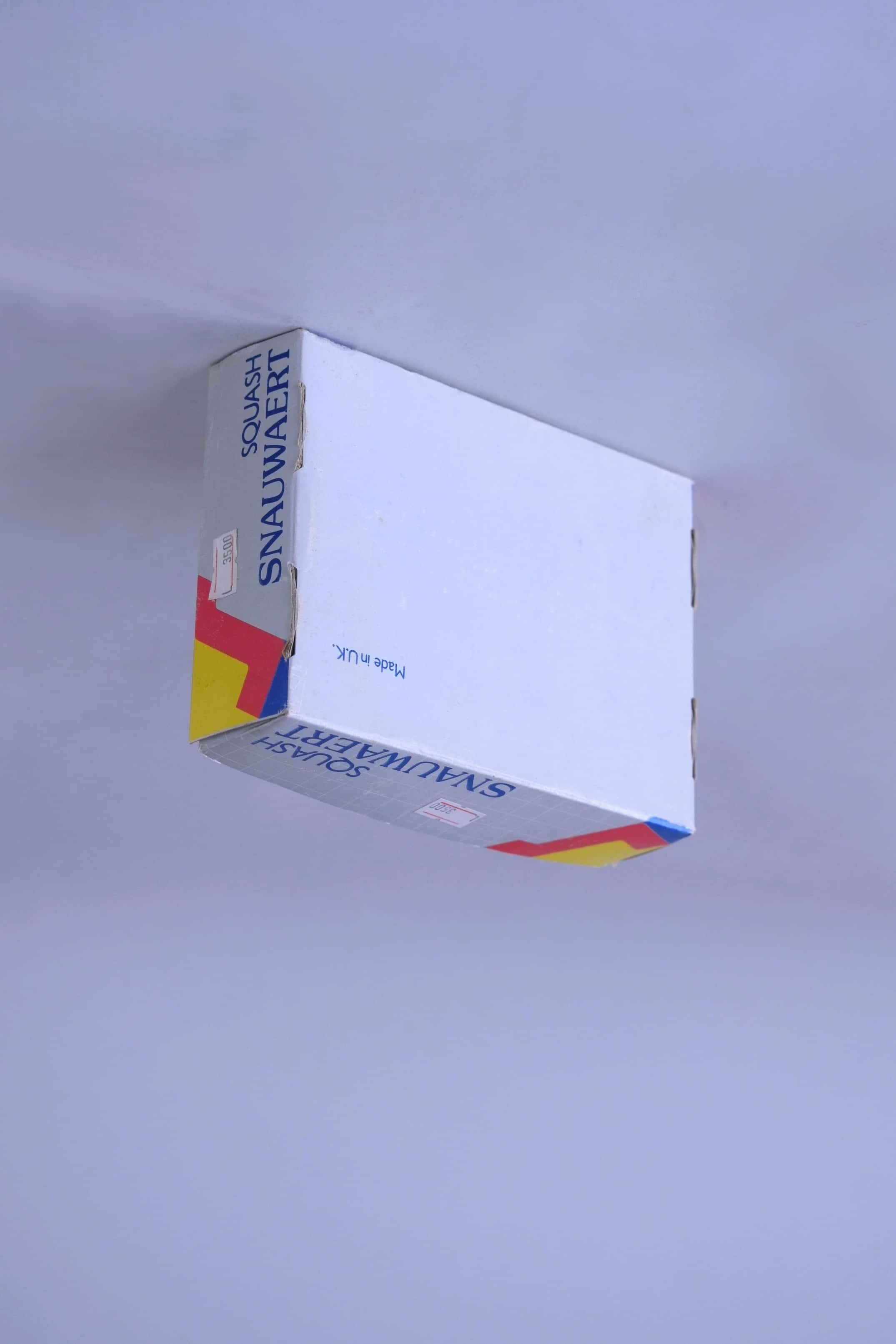 Bottom view of a vintage Snauwaert Squash Power box showing the Made in UK manufacturing text.