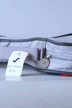 Close-up of the original deadstock white and blue Snauwaert cardboard retail hang-tag and the branded zipper.