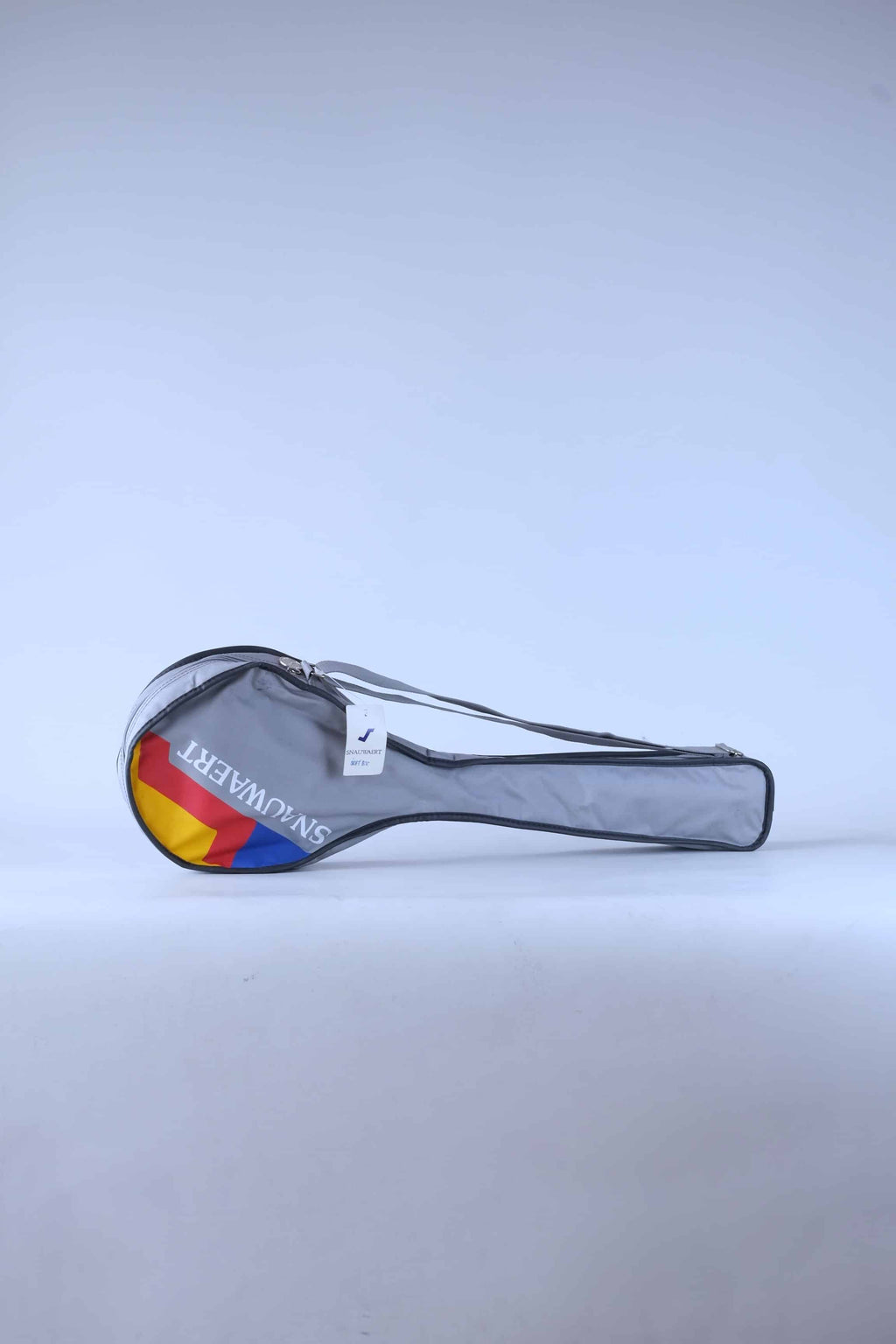 Front view of a vintage grey Snauwaert squash racket soft bag with a shoulder strap and red, yellow and blue brand logo.