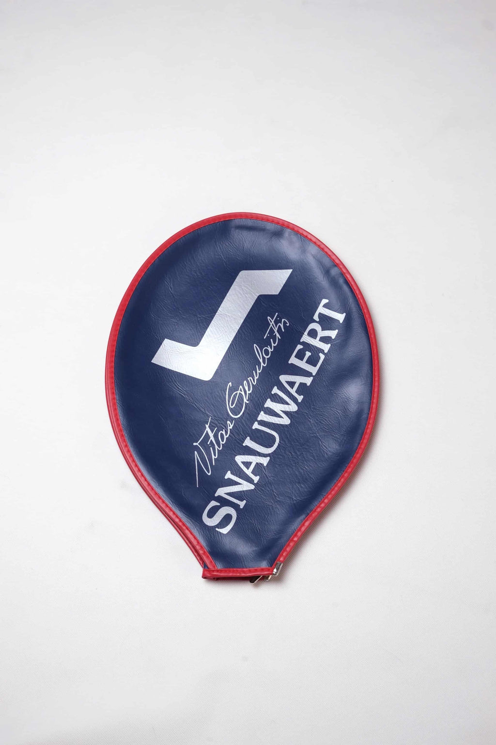 Vintage navy blue vinyl Snauwaert tennis racquet head cover with bright red trim, featuring a white logo and Vitas Gerulaitis signature text.