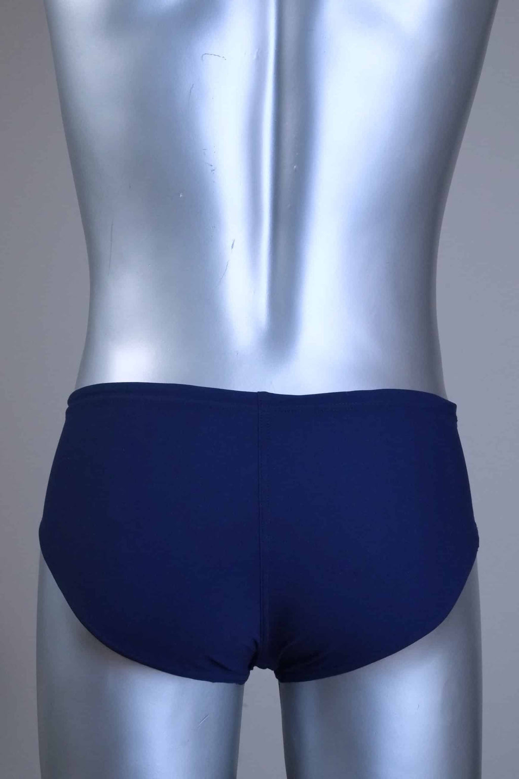 Back view of a pair of a Vintage navy men's swim briefs with white stripes on a metallic mannequin against a gray background