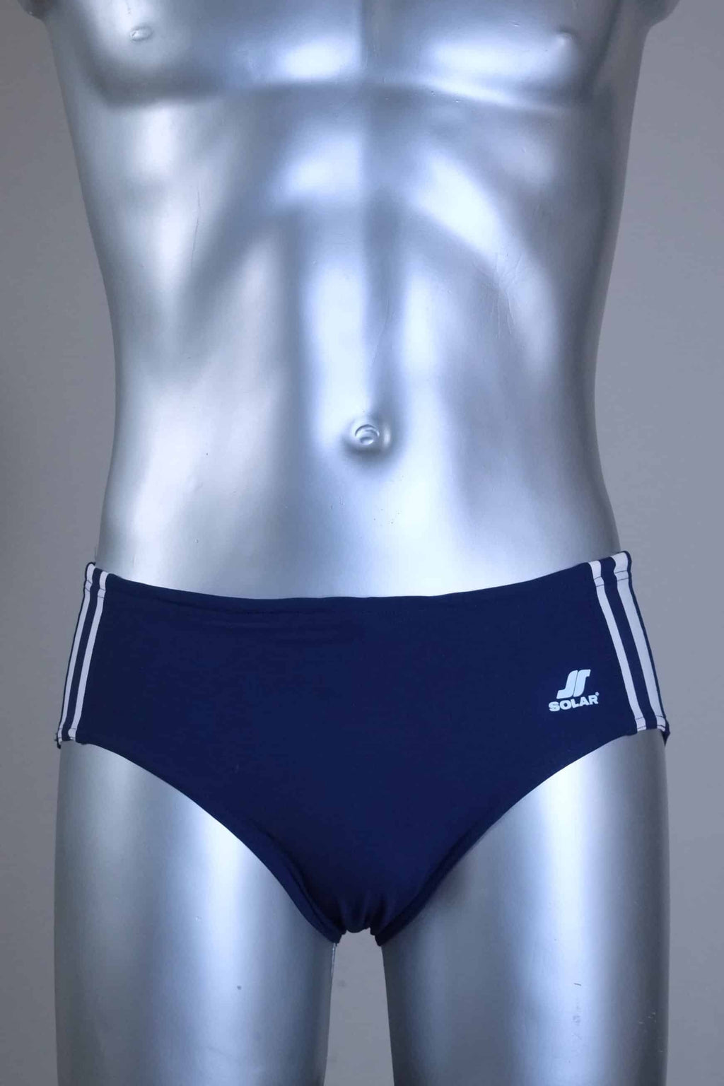 A pair of a Vintage navy men's swim briefs with white stripes on a metallic mannequin against a gray background