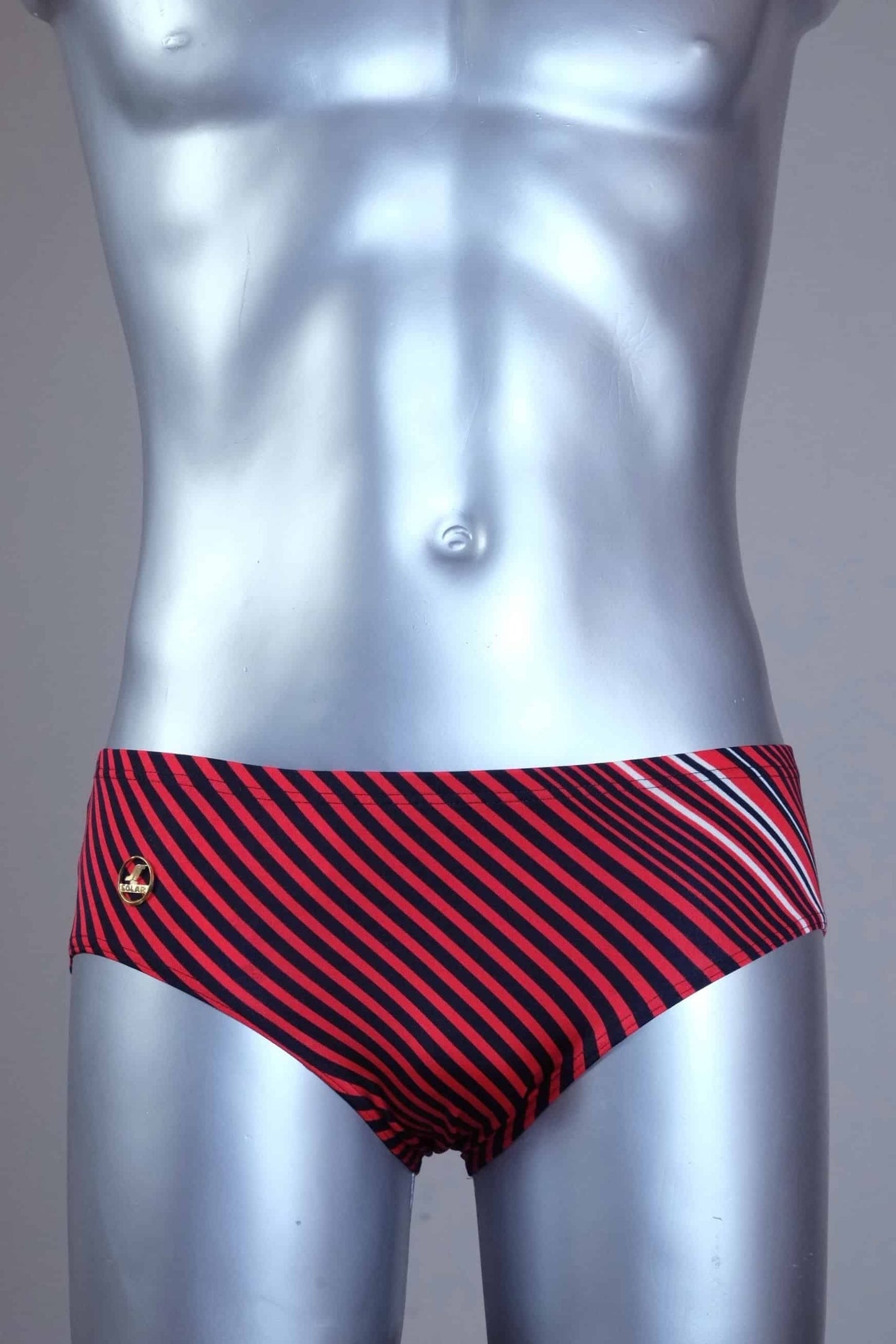 Red striped men's Solar swim briefs on a silver mannequin against a gray background