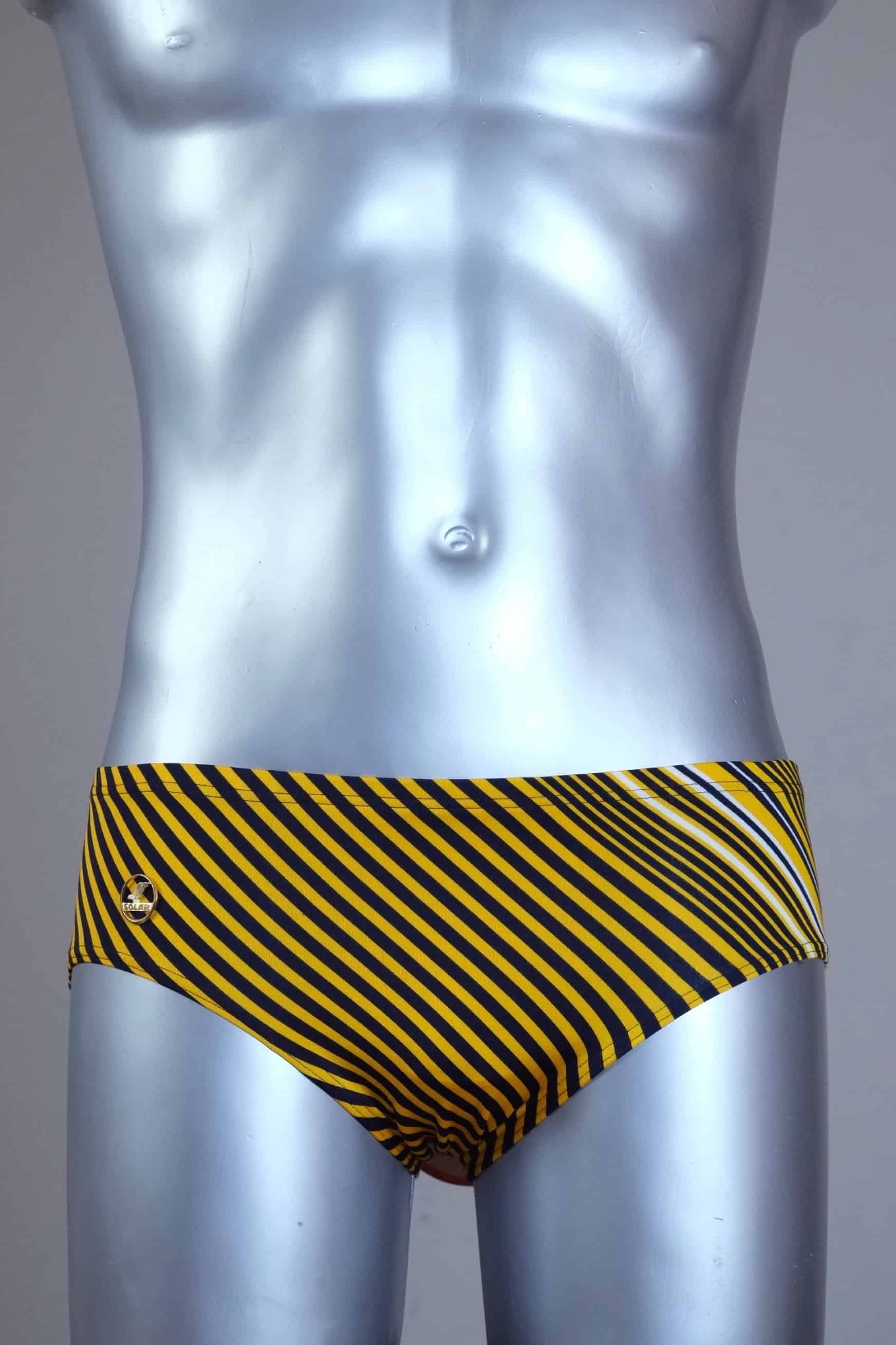 Yellow striped men's Solar swim briefs on a silver mannequin against a gray background