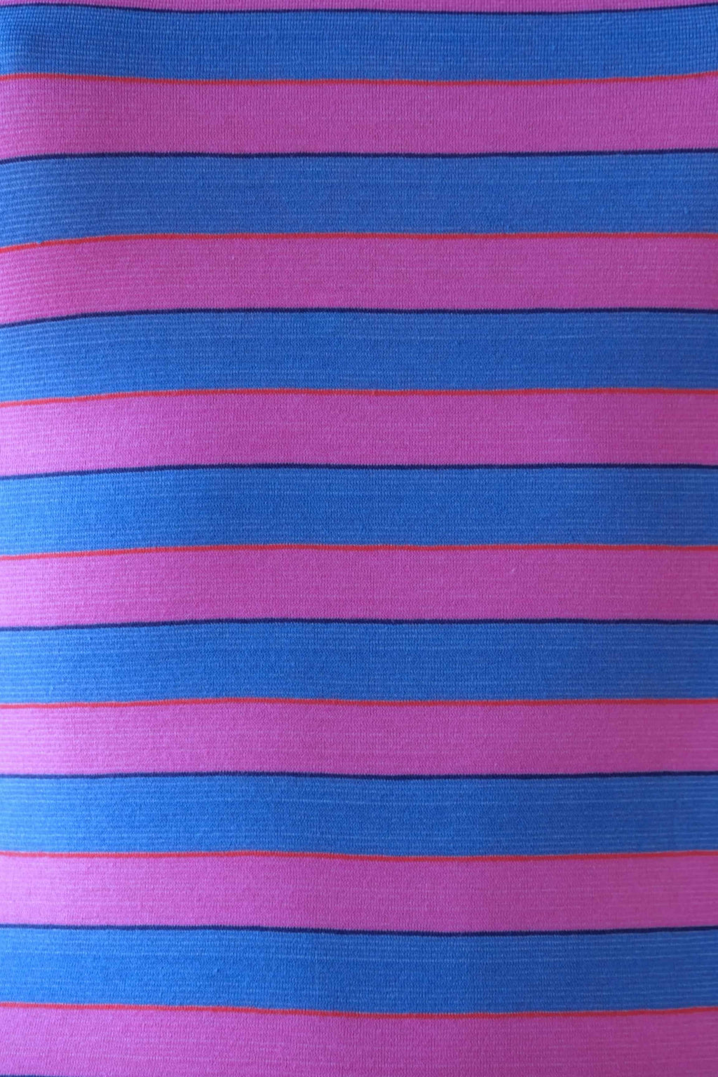 Close-up of Solar vintage 80s ribbed cotton fabric — wide bold horizontal stripes in pink and blue with narrow red and navy accent lines, texture detail.