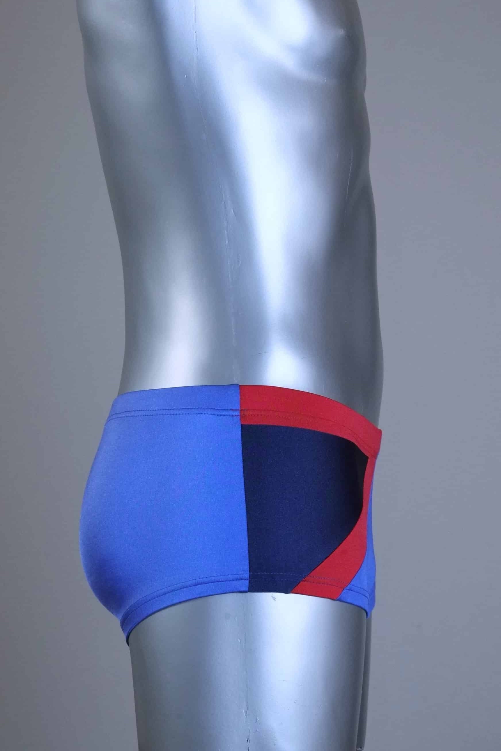 Side view of A pair of SOLAR vintage 80s men's square-cut swim briefs in purple with a red and black diagonal color block shown on a mannequin