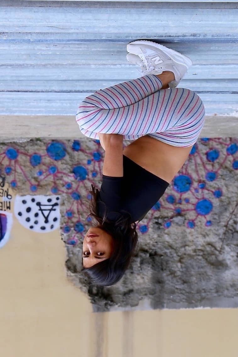 Solar vintage 80s micro stripe cotton leggings worn on a female model — fine pink and blue stripes on heather grey base, slim full-length cut, squatting pose, styled with New Balance sneakers, side view
