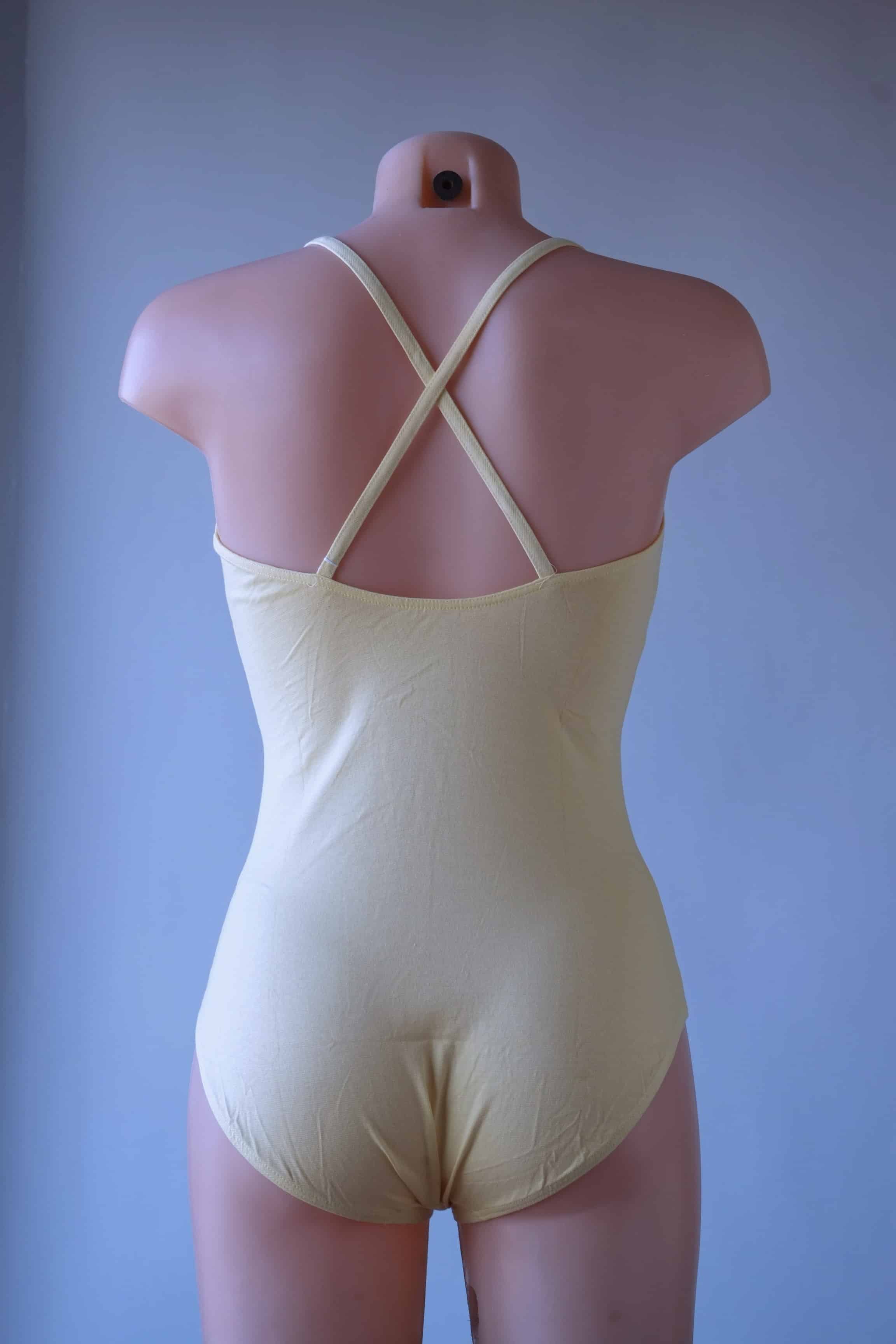 Solar vintage 80s cotton leotard in pale yellow, worn on a mannequin — square neckline with thin spaghetti straps, clean minimal back view