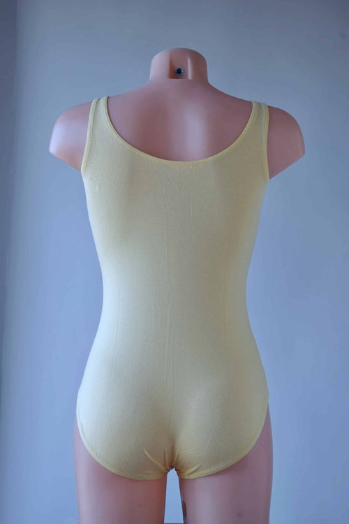 Rear view of the yellow Solar leotard featuring a classic scoop back and cotton texture.