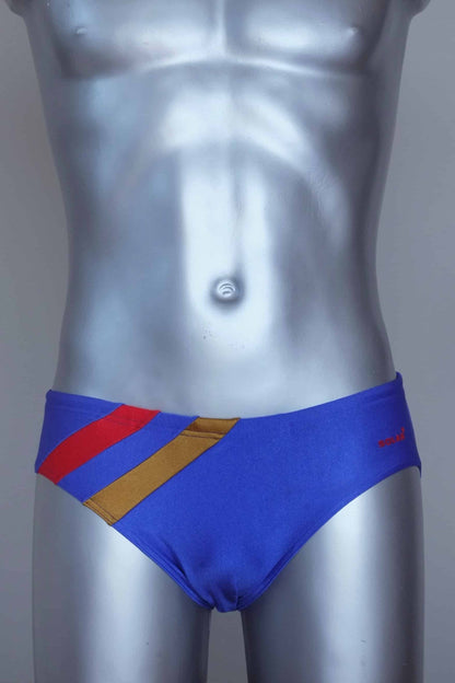 Vintage solar Blue men's swim briefs with red and yellow stripes on a silver mannequin against a grey background.