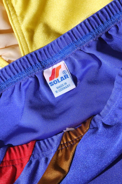 Close-up of a blue garment with a Solar label on a multicolored background