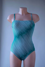 Solar vintage 80s diagonal stripe spaghetti strap leotard worn on a mannequin — green and white diagonal cross stripes, straight bandeau neckline, spaghetti straps, high cut leg, front view