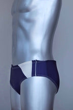 Side view of a vintage navy men's swim briefs on a silver mannequin against a gray background