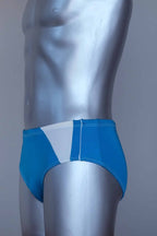Side view of a vintage turquoise men's swim briefs on a silver mannequin against a gray background