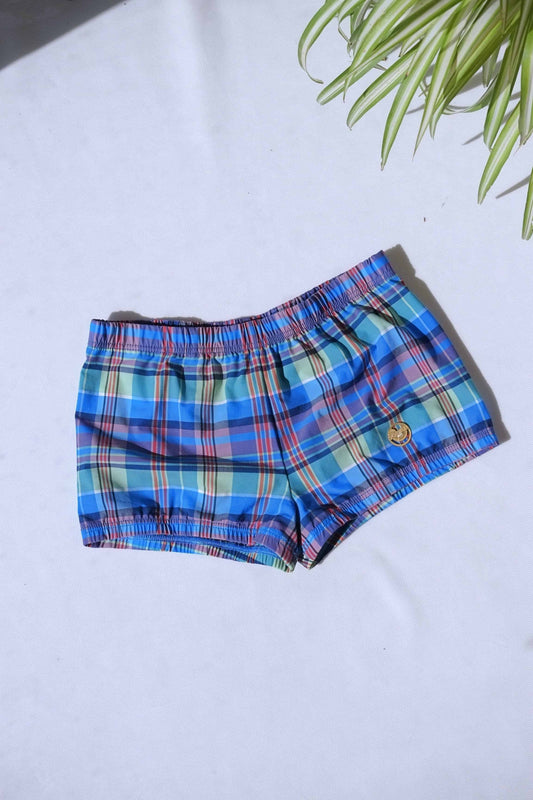 A single pair of SOLAR brand vintage 70s men's blue and green plaid square-cut swim briefs with a gold metal logo.