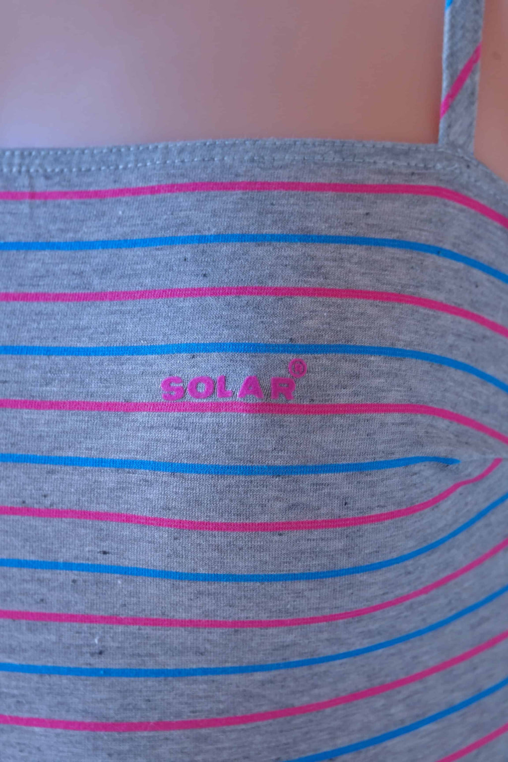 Close-up of Solar vintage 80s pinstripe cotton leotard worn on a mannequin — Solar logo detail on heather grey fabric with fine pink and blue horizontal micro-stripes, strap detail visible