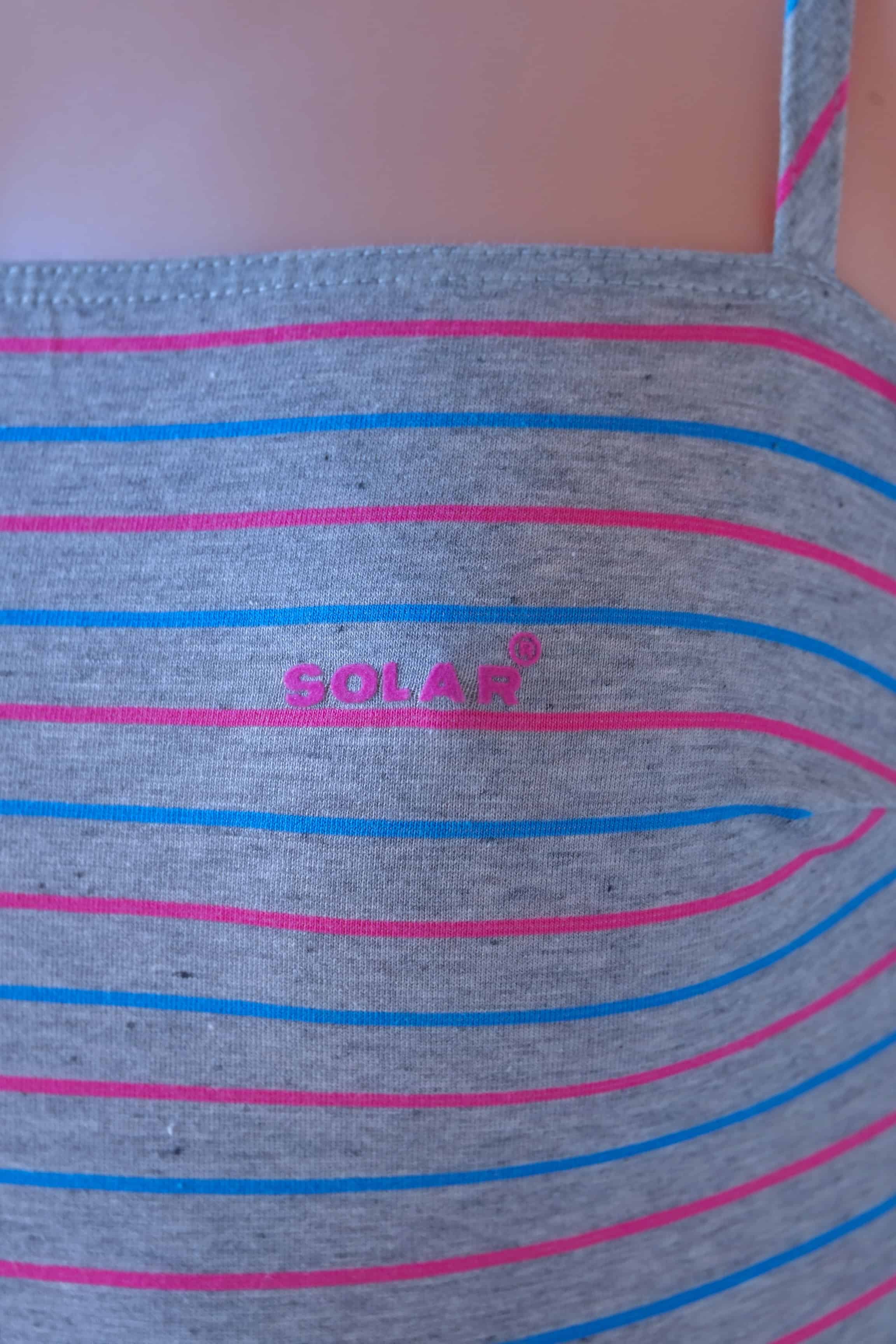 Close-up of Solar vintage 80s pinstripe cotton leotard worn on a mannequin — Solar logo detail on heather grey fabric with fine pink and blue horizontal micro-stripes, strap detail visible
